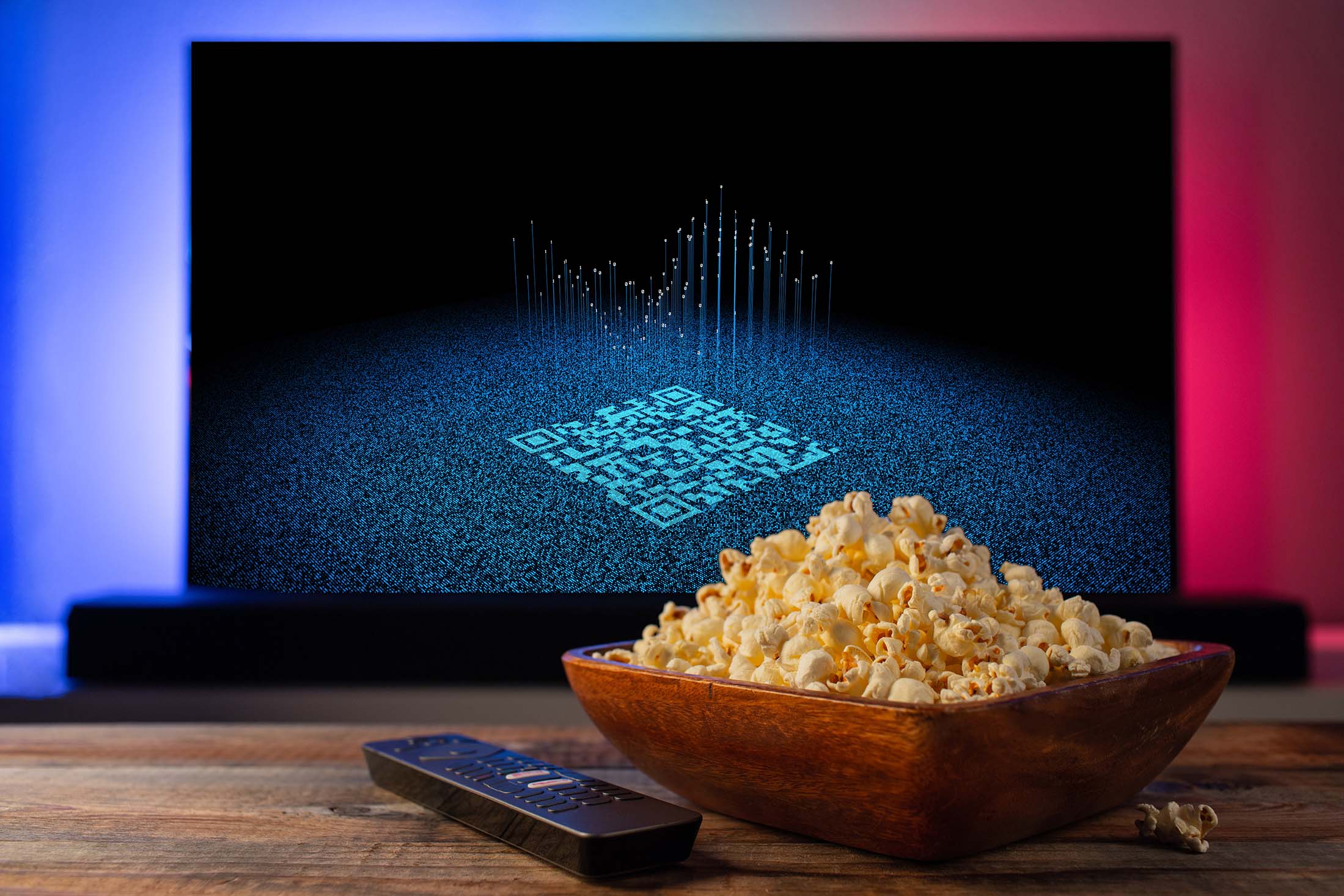 QR code on TV screen; bowl of popcorn